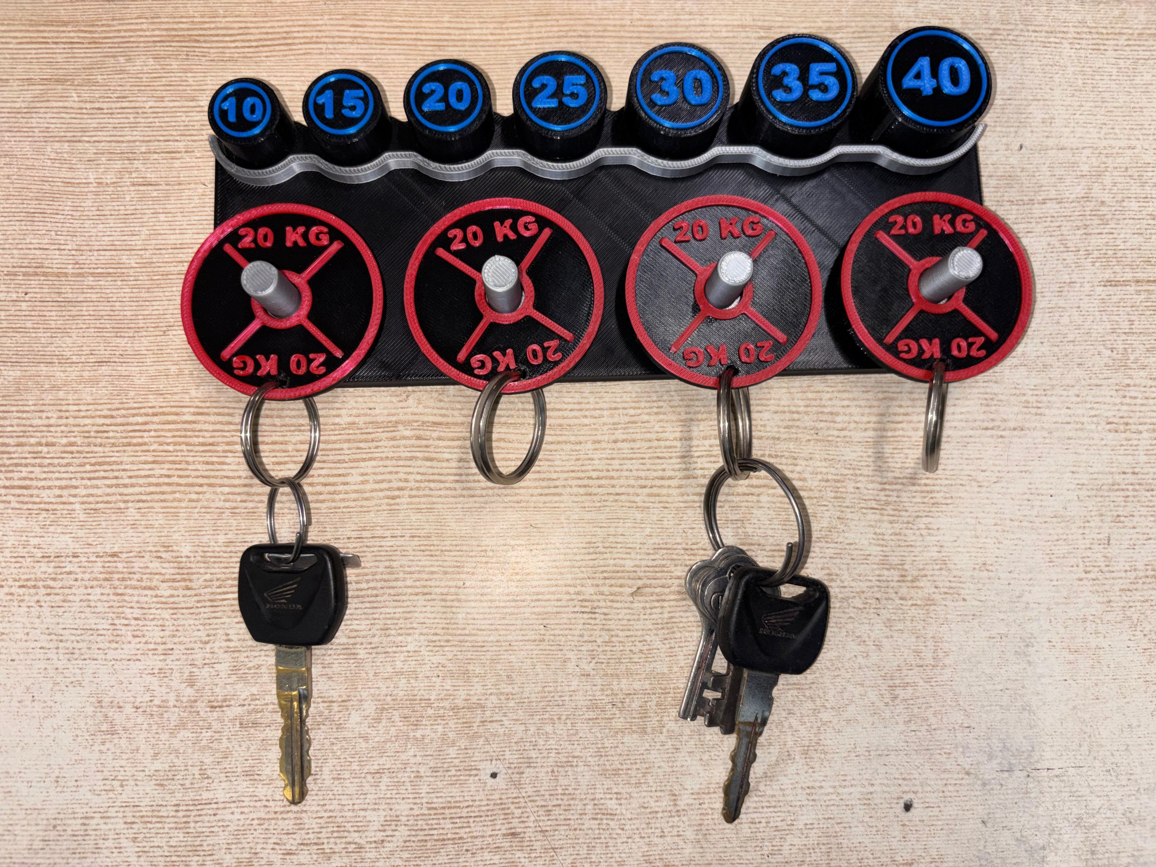 Set of weightlifting keys with weight indicators on a textured surface